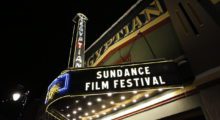 Park City, Utah's Egyptian Theater lit-up at night, the marquee reads "Sundance Film Festival"