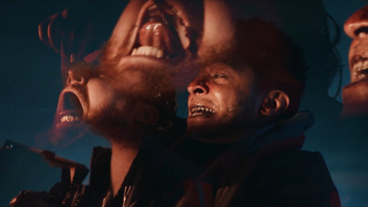 Two men stand side by side with anguished looks on their faces. In psychedelic fashion, their faces are repeated kaleidoscopically in the frame.