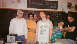 A photo that appears to be from the late '90s/early aughts featuring an array of geeky tech bros.