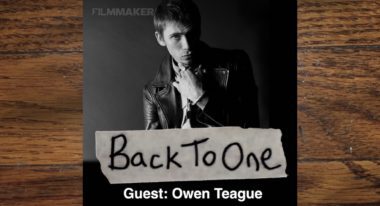 A headshot of actor Owen Teague wearing a black leather motorcycle jacket.