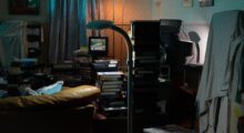 Stacks of VHS tapes in a cramped apartment.