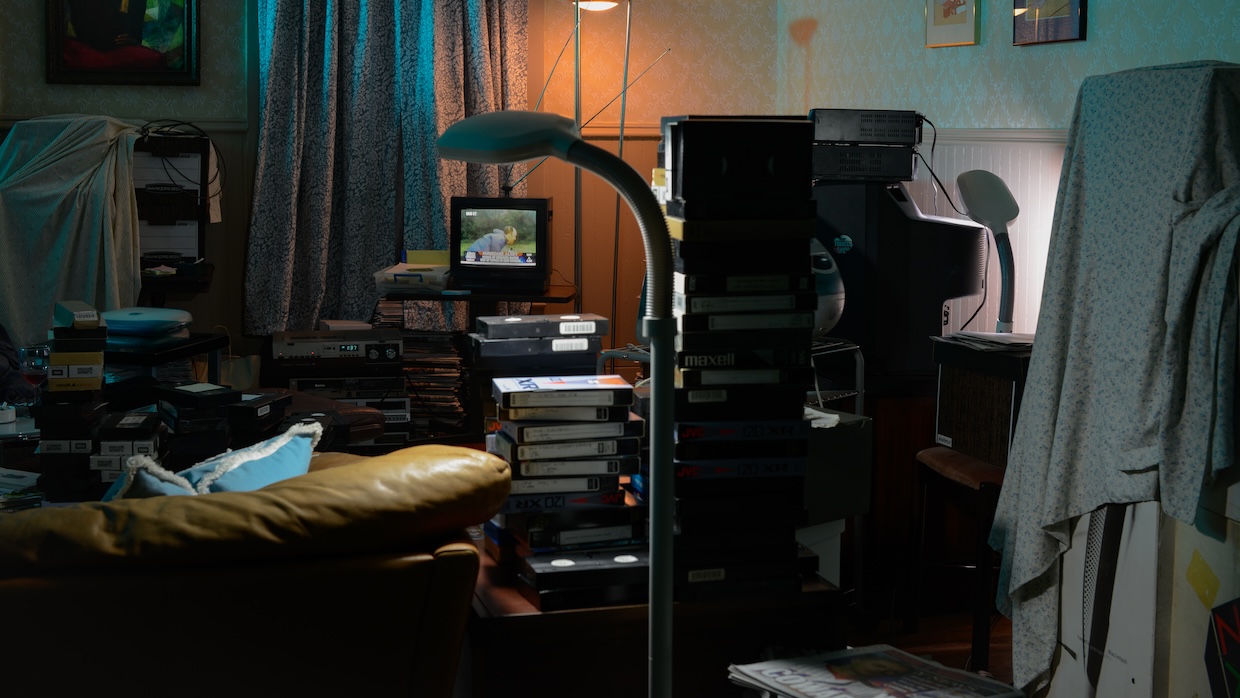Stacks of VHS tapes in a cramped apartment.