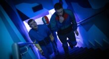 Three Irish men dressed in blue ascend a staircase. The man in the back is wearing a red, white and blue ski mask.