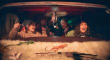 Teenagers scream in a car at night.
