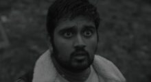 Black-and-white close-up of a wide-eyed man.