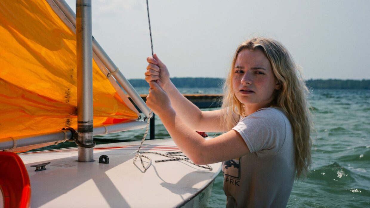 A white woman is sailing.