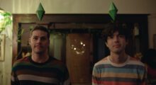 Two-shot of a pair of men in colorful striped shirts look