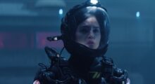 A woman in a spacesuit looks concerned.