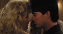 Two young people dance close to each other.