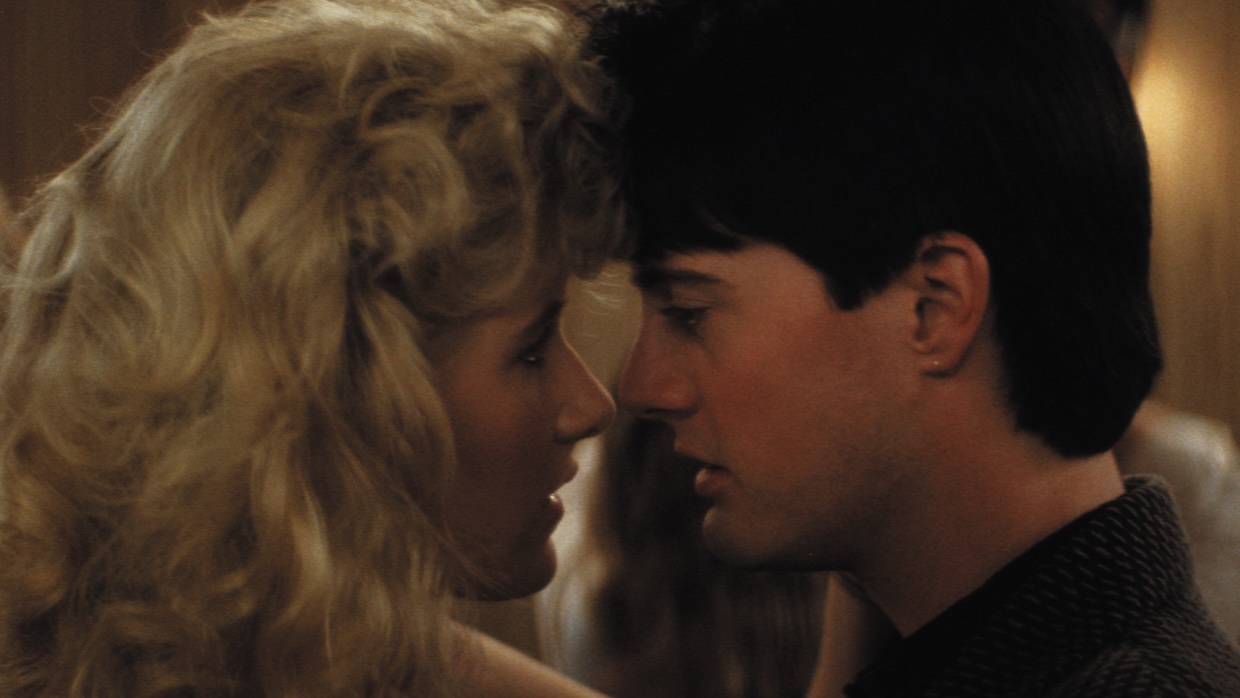 Two young people dance close to each other.