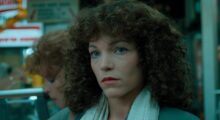 A woman stares pensively.