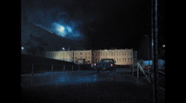 A truck drives through a dark and stormy night.