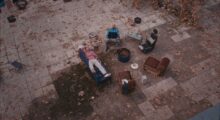 Two men relax in a courtyard.