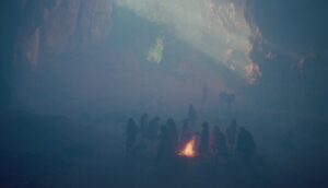 Children cluster around a small fire in a smoggy quarry.
