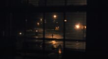A child runs under streetlights.