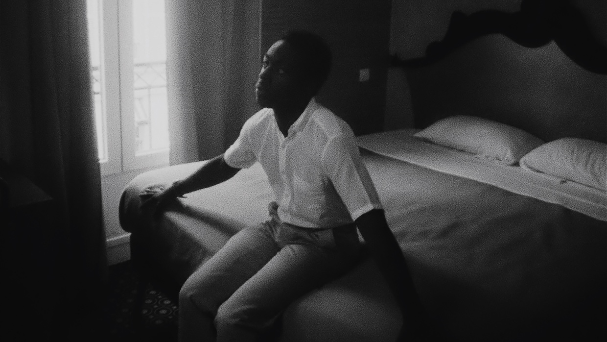 A man sits on a bed.