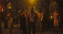 The ensemble cast of Sinners, in character, as they stand sweaty and scared before a battle with vampires.