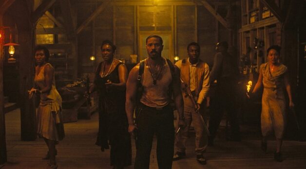 The ensemble cast of Sinners, in character, as they stand sweaty and scared before a battle with vampires.