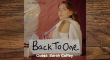Actress Sarah Coffey's headshot, she wears a white jacket and turns her head toward the camera