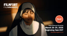 A nun closes her eyes and stands against a wall as light seeps in from a window and covers half of her face.