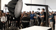 A group of people gather around to watch a professional lighting demonstration at NAB.